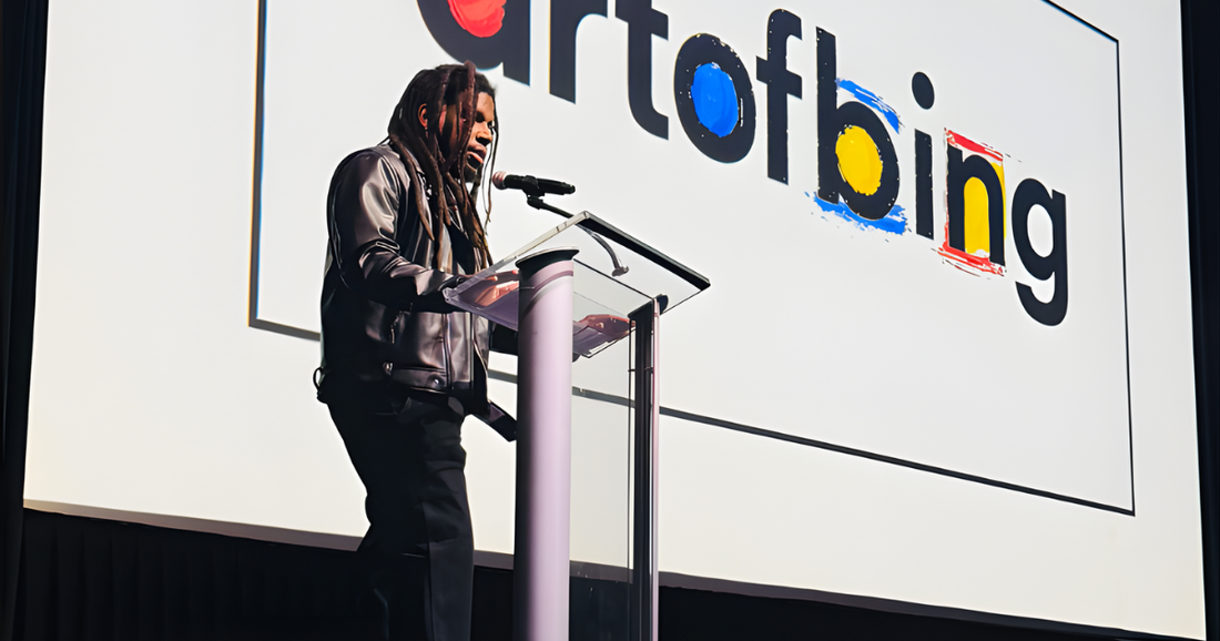 Charleston artist Demetrius Bing presenting on stage at Pecha Kucha 49 in front of the Art of Bing logo
