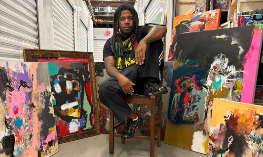 Charleston artist Demetrius Bing with original paintings featured in the final season of Outer Banks